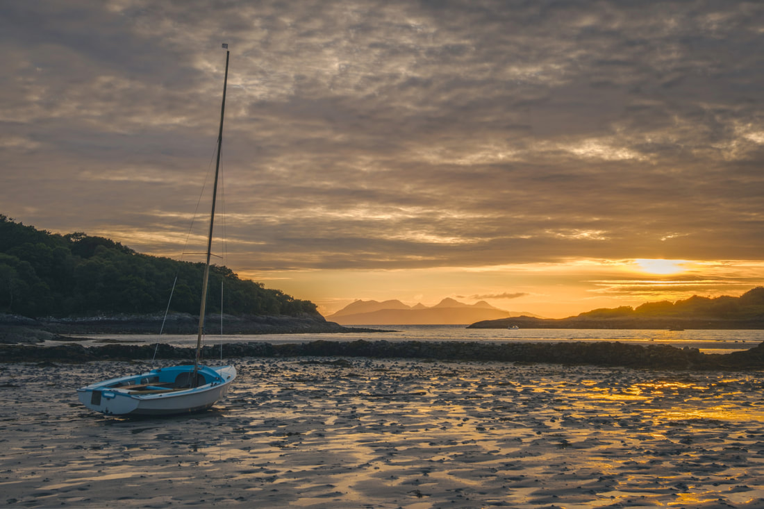 A sailboat on the sand at Samalaman Bay near Glenuig during a golden summer sunset | Moidart, Scotland | Steven Marshall Photography